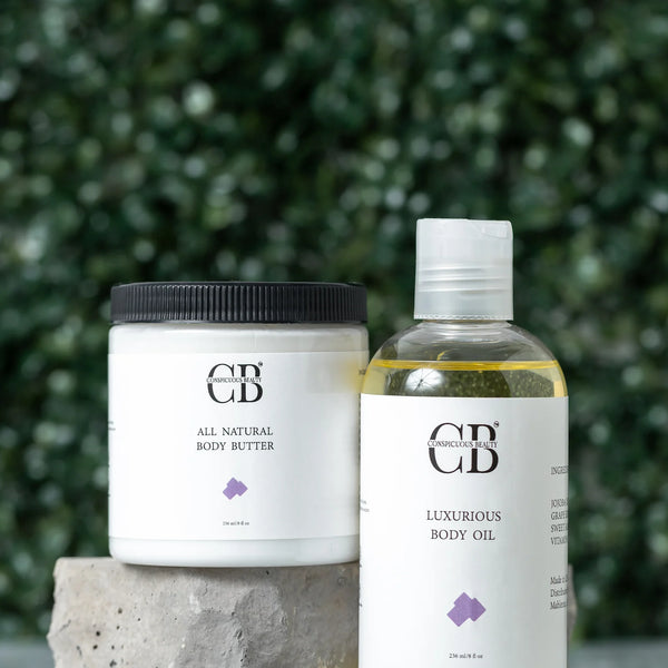 All natural body butter and luxurious body oil with visible brand logo against a green foliage background.