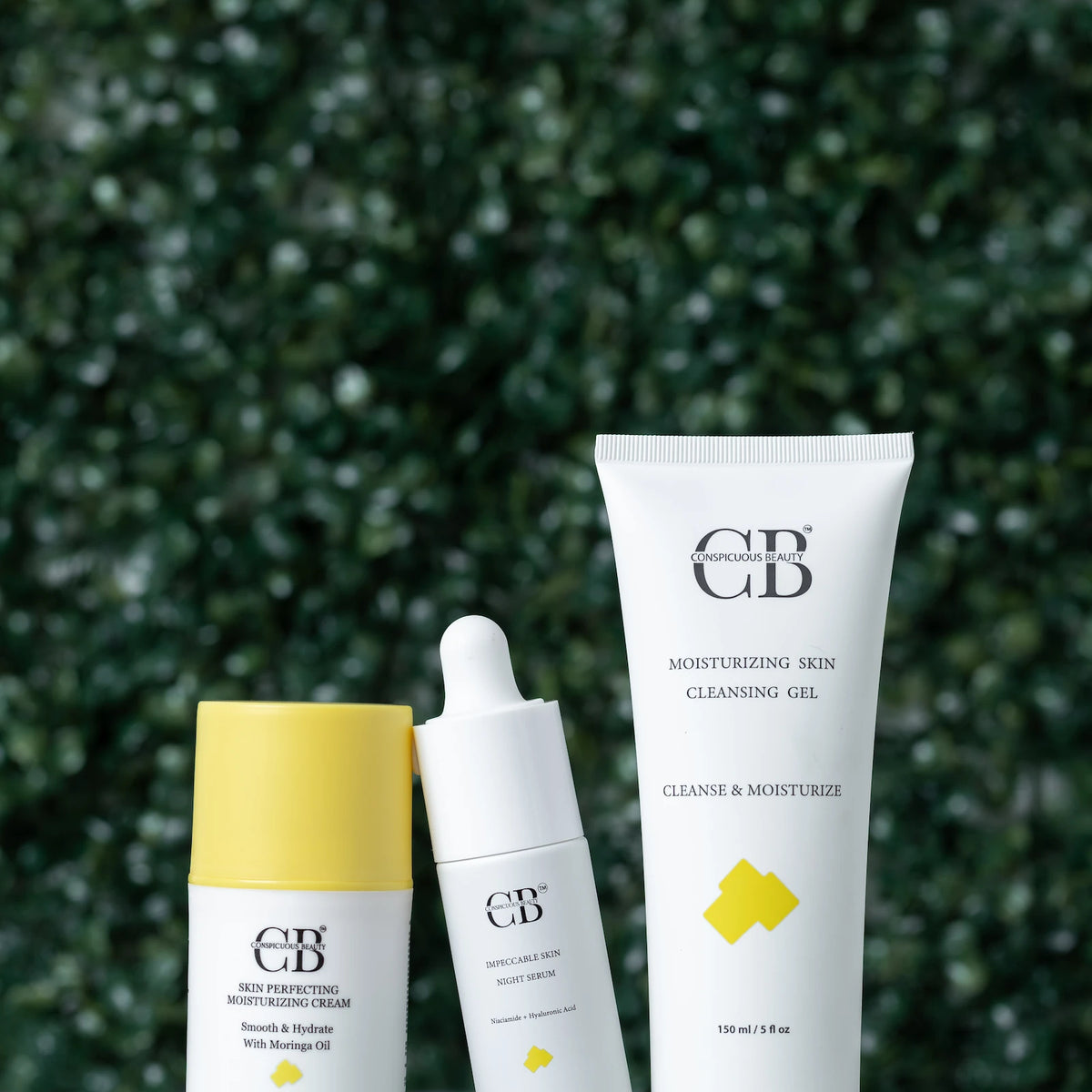 Facial skincare bundle with visible branding against a green foliage background